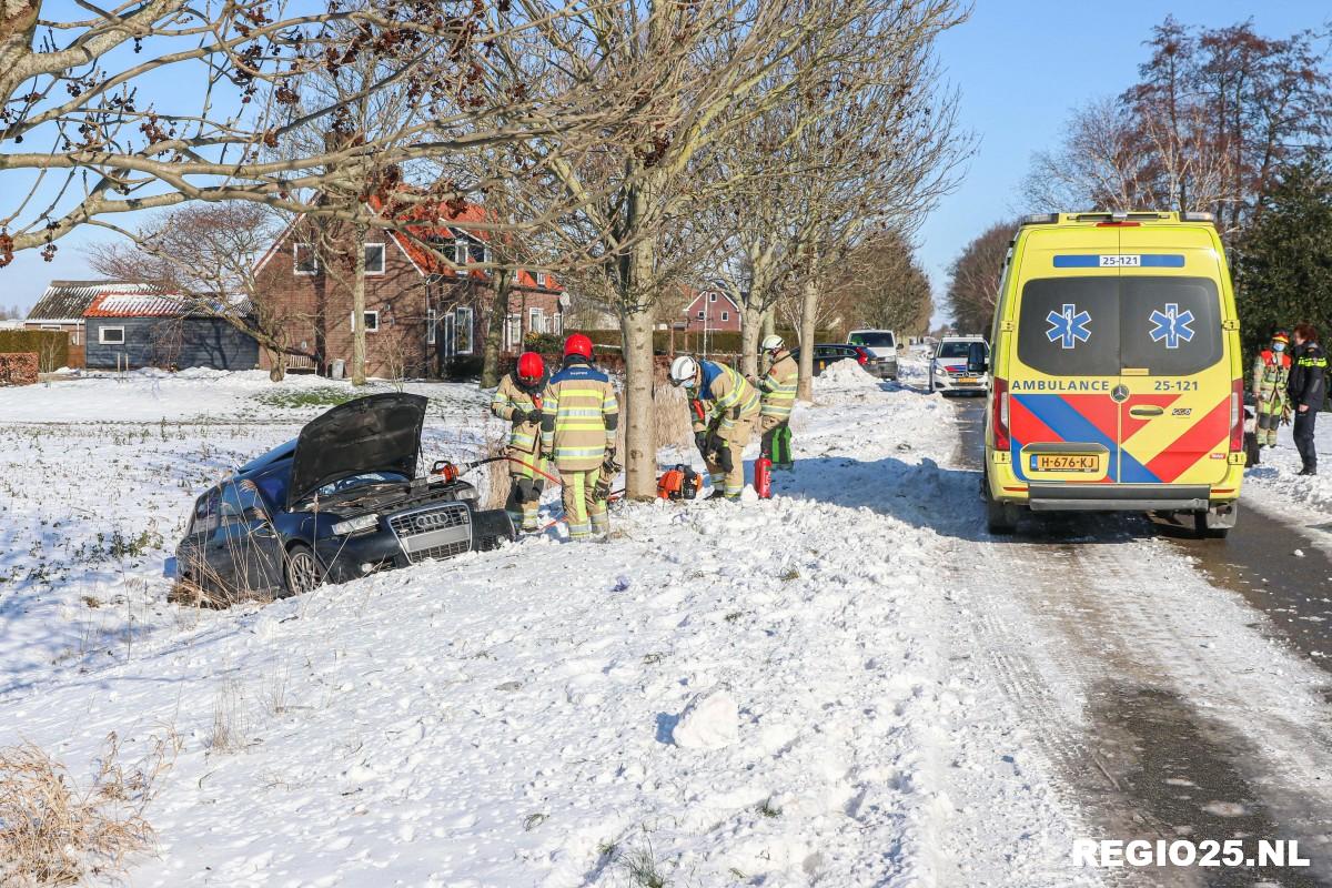 Auto tegen boom door sneeuw en slechte banden